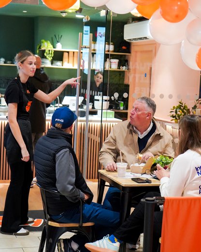 A friendly moment with customers at the new store